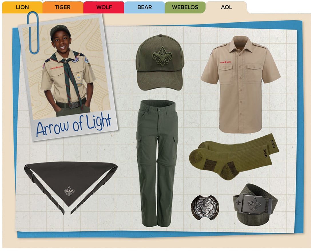 Official Arrow of Light uniform: tan shirt, green cap, green pants, green belt, green socks, and a dark neckerchief.